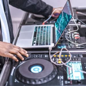 DJ sorting through songs to play at a gig. DJ Service Packs make it easier for DJs to play your music.