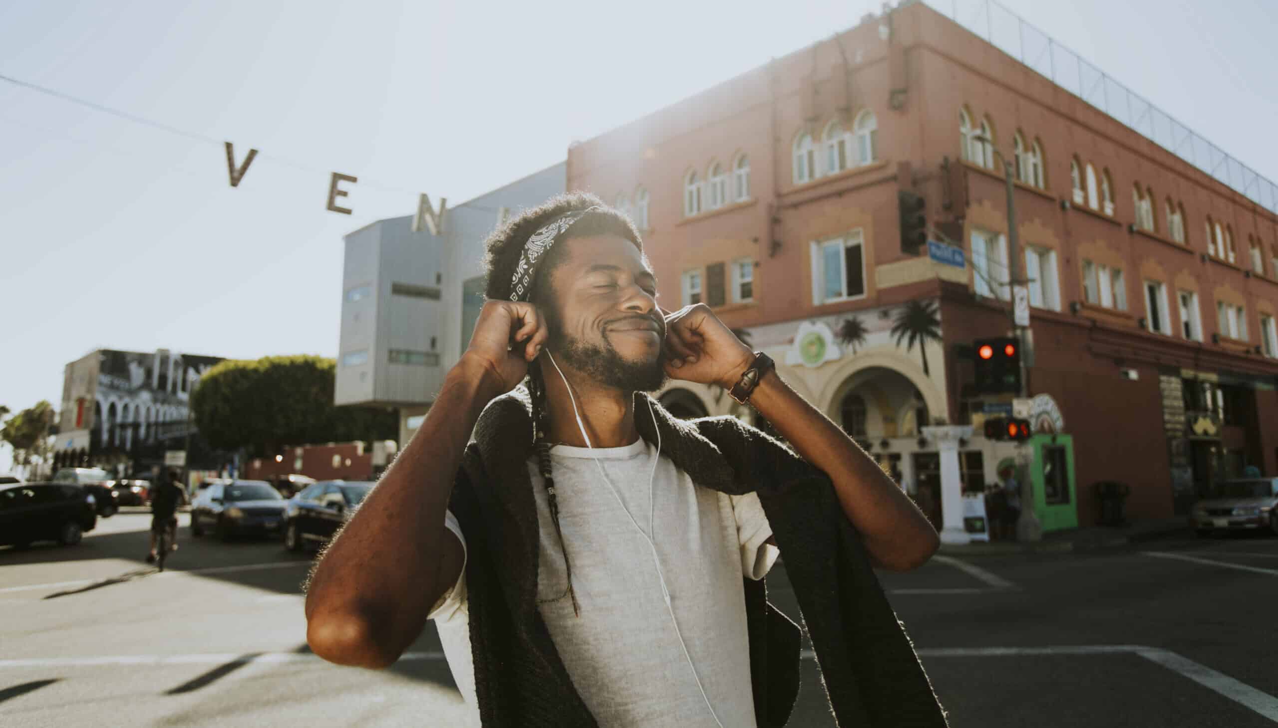 Young man enjoying music while out and about.