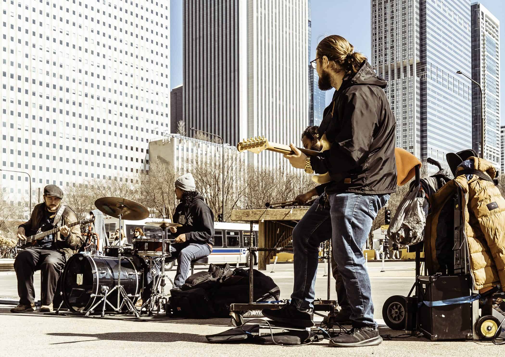 A man playing guitar in front of a group of people