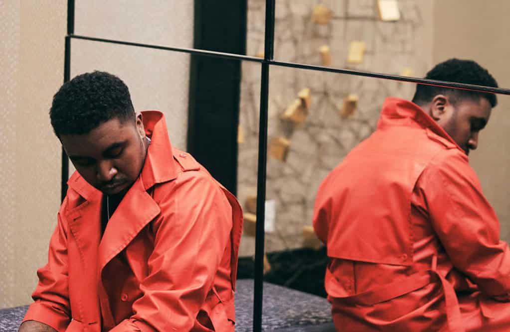 JAMES ARTISSEN in an orange coat